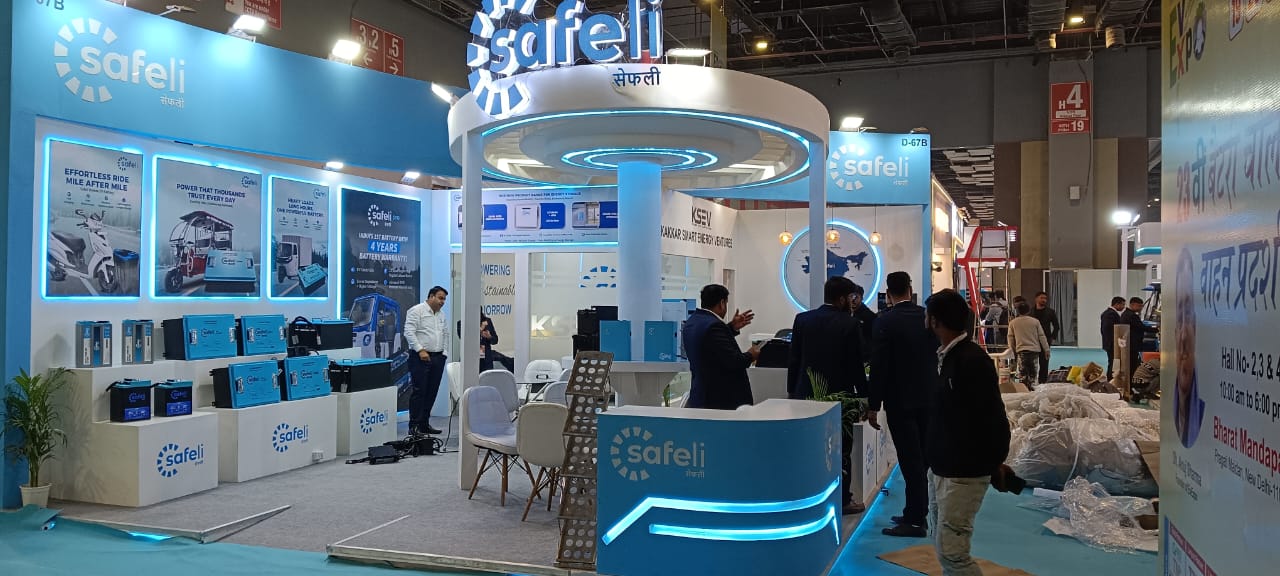 Trade show booth design with hanging banner and spot lighting